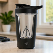 Black portable juicer blender with transparent cup and power button on kitchen counter